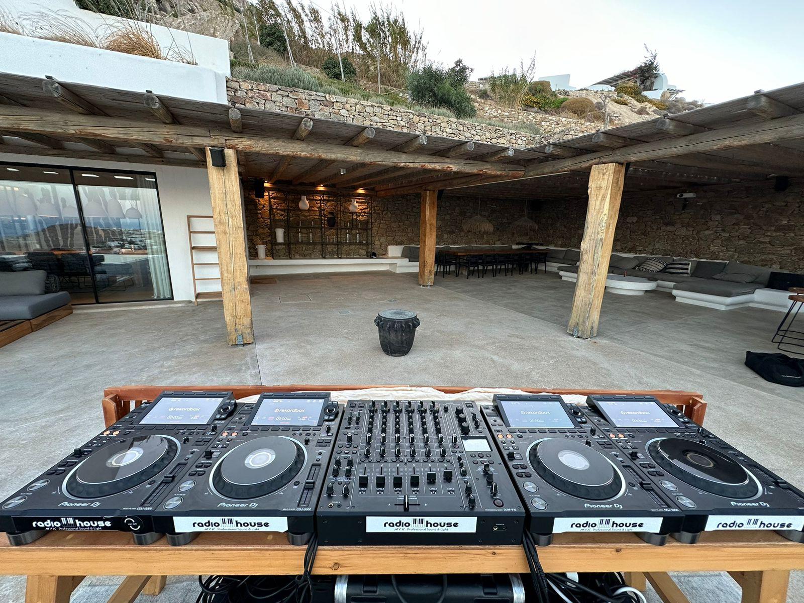 RadioHouse DJ booth with two Pioneer CDJ-3000 players and a DJM mixer set up on a Mykonos villa terrace
