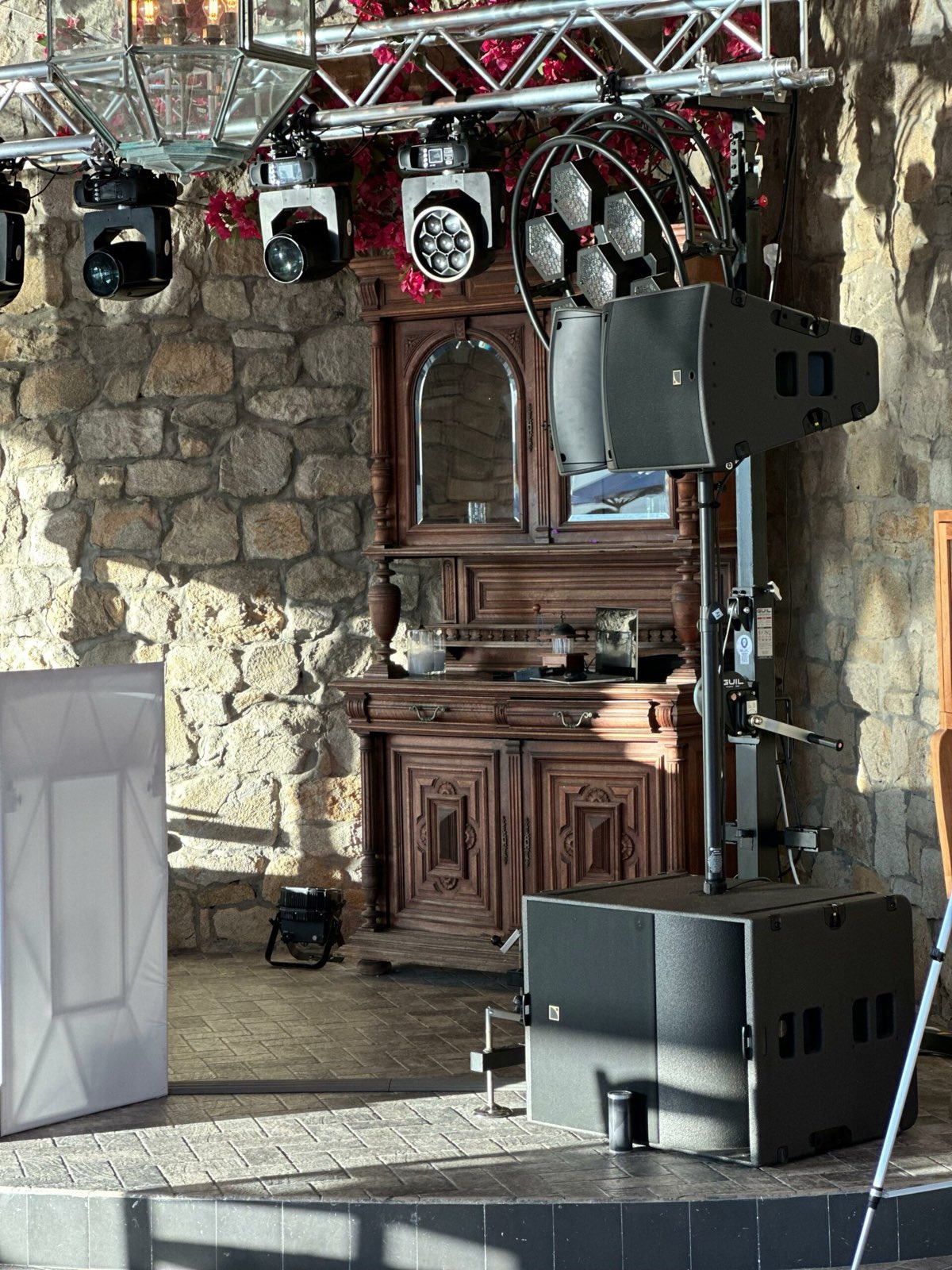 Loudspeakers rigged inside a traditional stone-walled venue in Mykonos